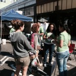 Susy Rojas and Nathaly De Leon answer questions at Mission Community Market.
